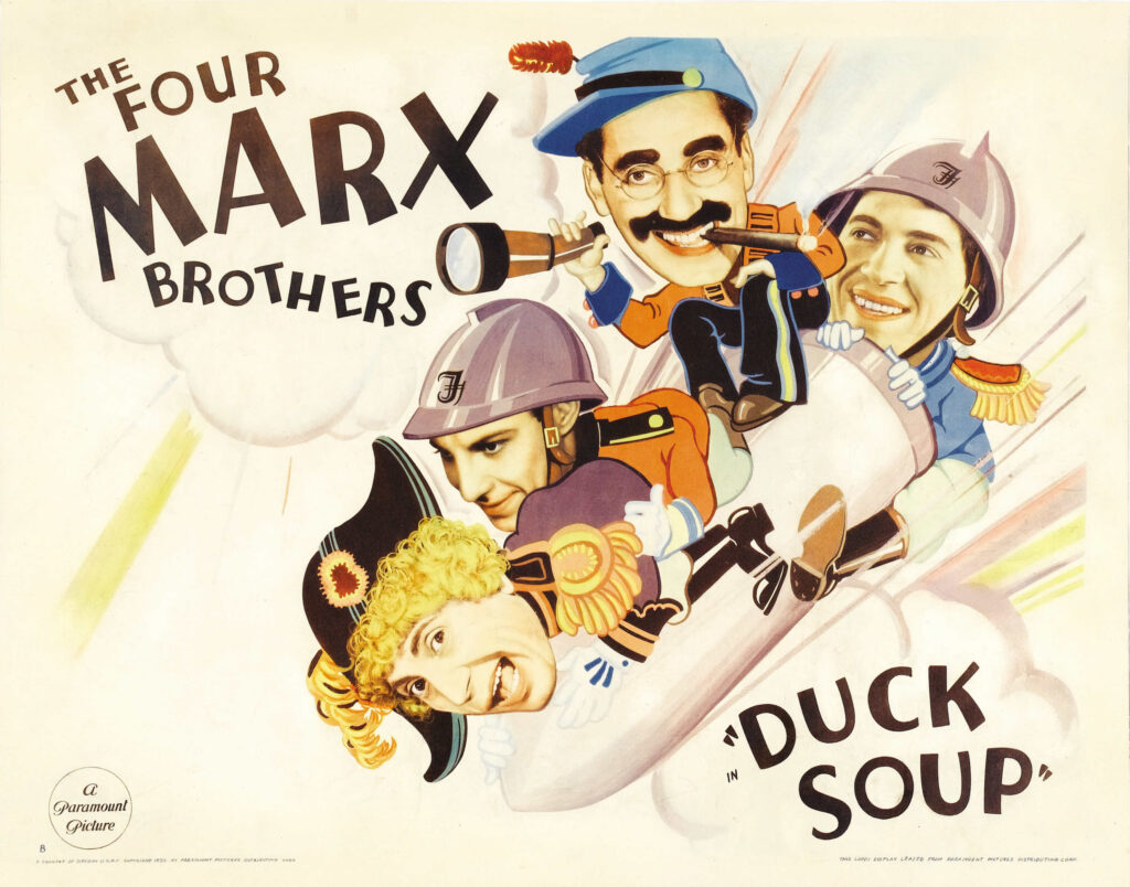 The Four Marx Brothers movie poster for Duck Soup, showing cartoonish brothers on a speeding aircraft with bold typography.